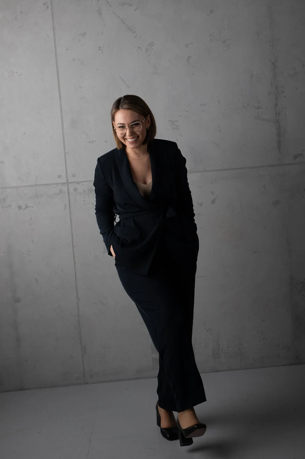 Eriselda Barjamaj, executive coach, laughing mid-step in a modern interior